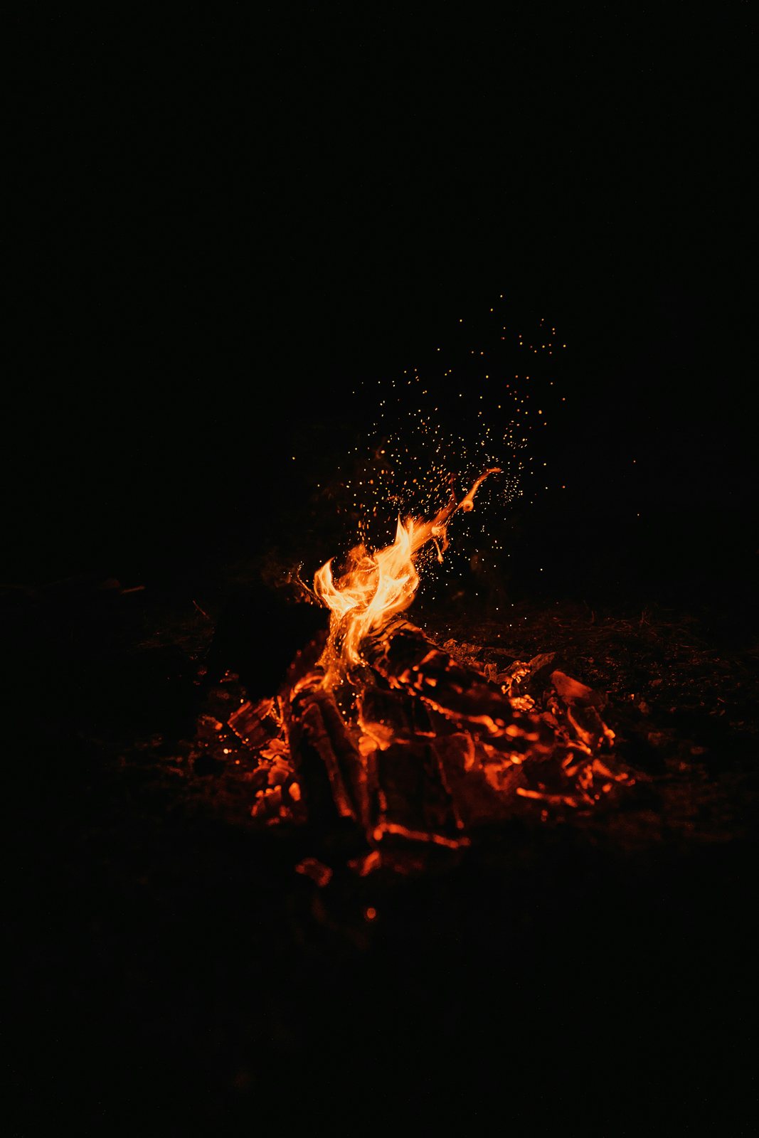 A small fire burning in the dark.